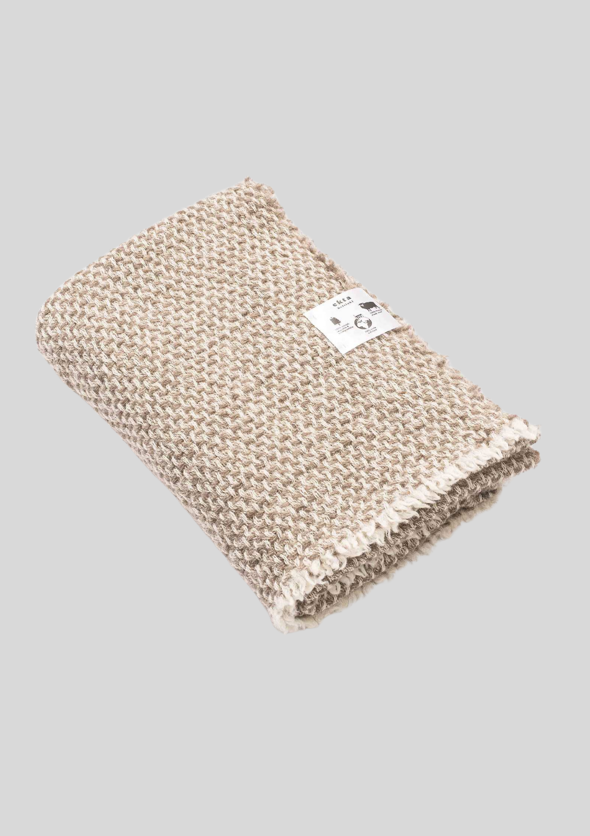 Textured pattern white and beige colored throw made out of responsible Finnish sheep wool. Manufactured in Finland.