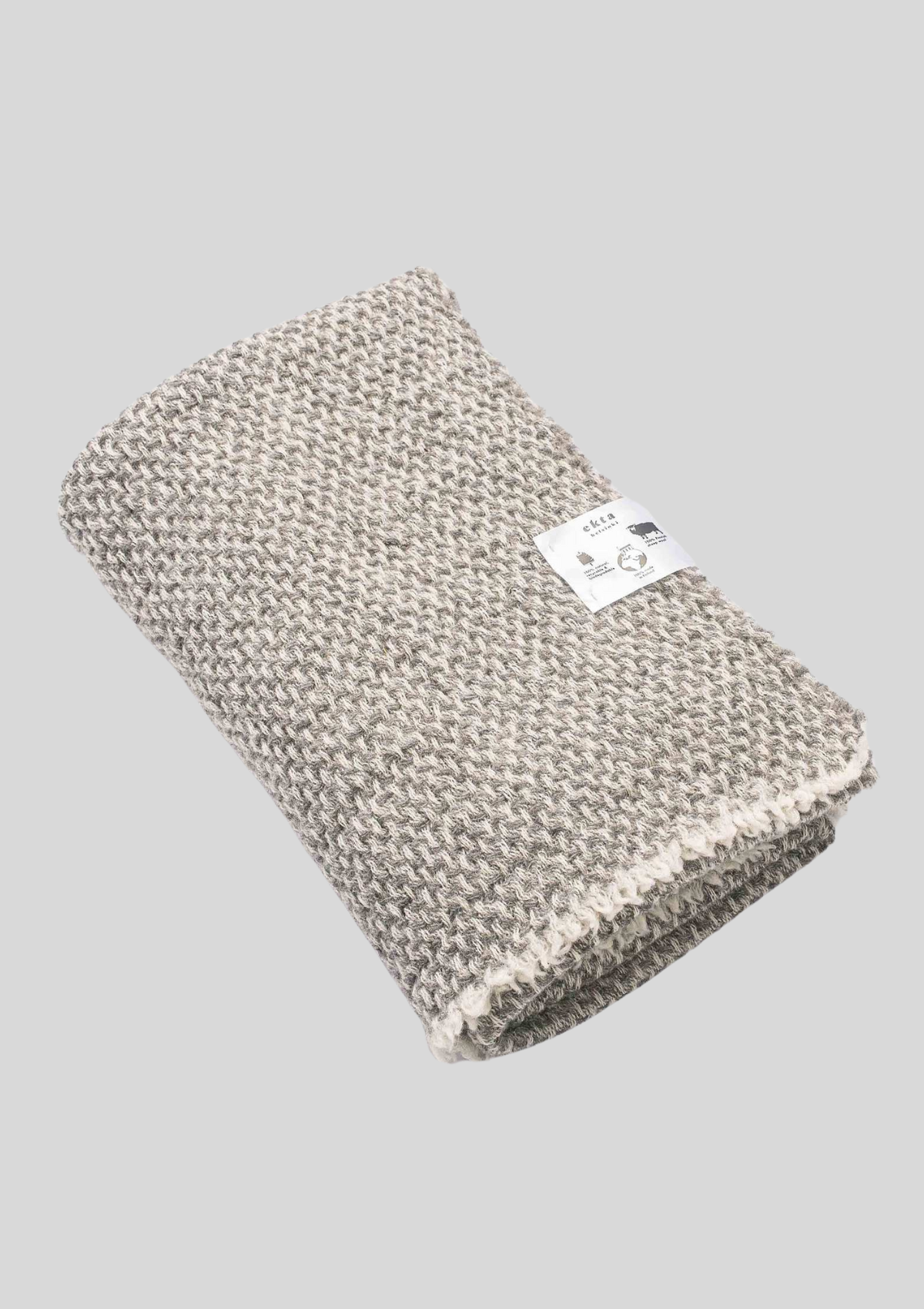 Textured pattern white and grey colored throw made out of responsible Finnish sheep wool. Manufactured in Finland.