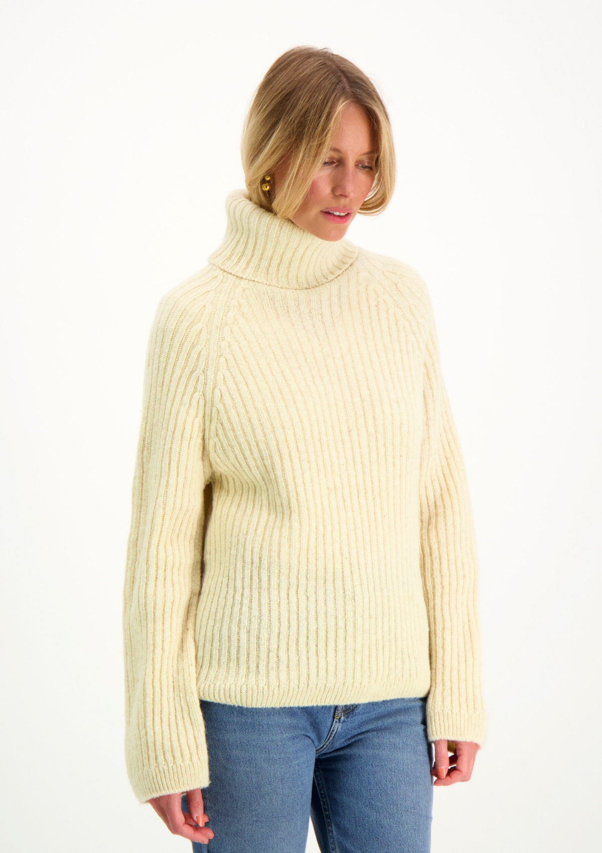 Ribbed white polo made from Finnish durable sheep wool. Sustainable and warm wool knit made in Finland.