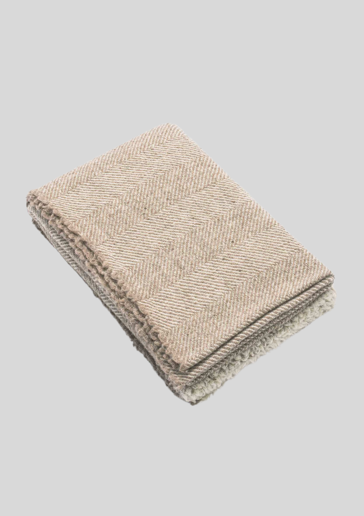Herringbone pattern white and beige coloured throw made out of responsible Finnish sheep wool. Manufactured in Finland.