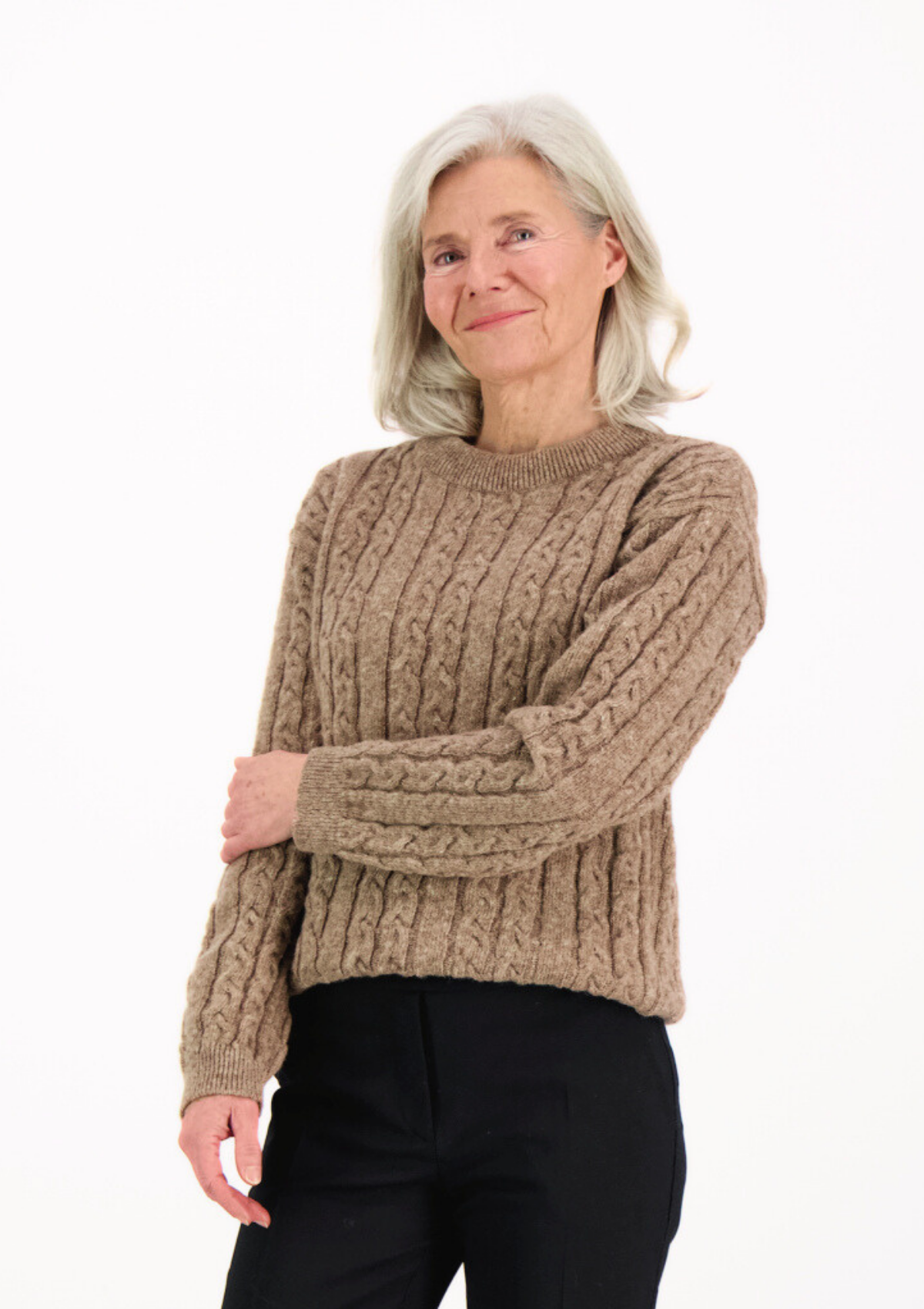 Soft and elegant cable knit in beige with o-neck. Made of responsible Finnish sheep wool in Finland.