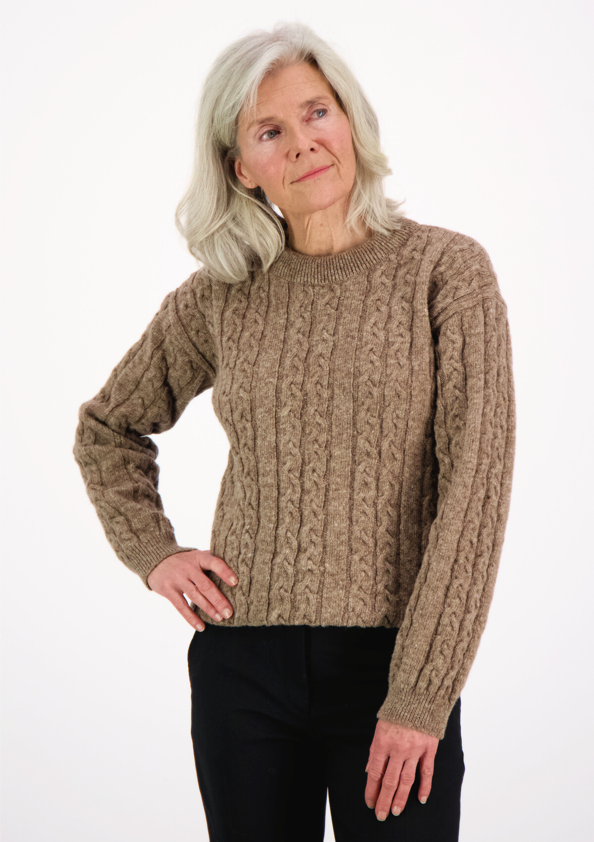 Soft and elegant cable knit in beige with o-neck. Made of responsible Finnish sheep wool in Finland.
