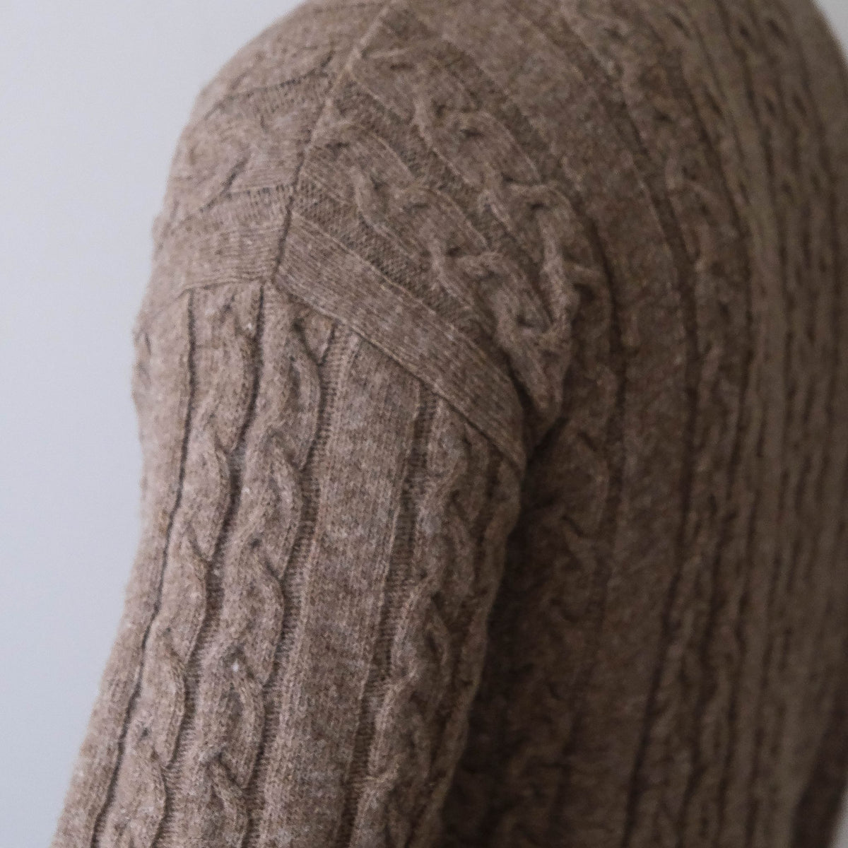 Soft and elegant cable knit in beige with an O-neck. Made of responsible Finnish sheep wool in Finland.