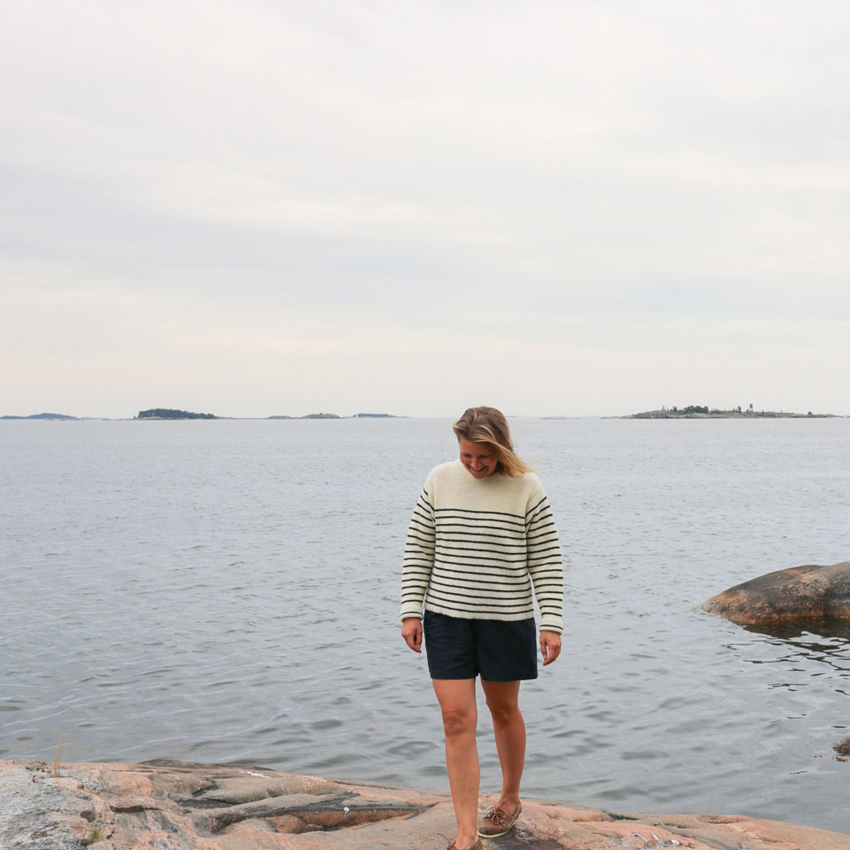 Striped black and white sweater with round neck. Manufactured in Finland of Finnish sheep wool. Nordic pure sustainable knitwear.