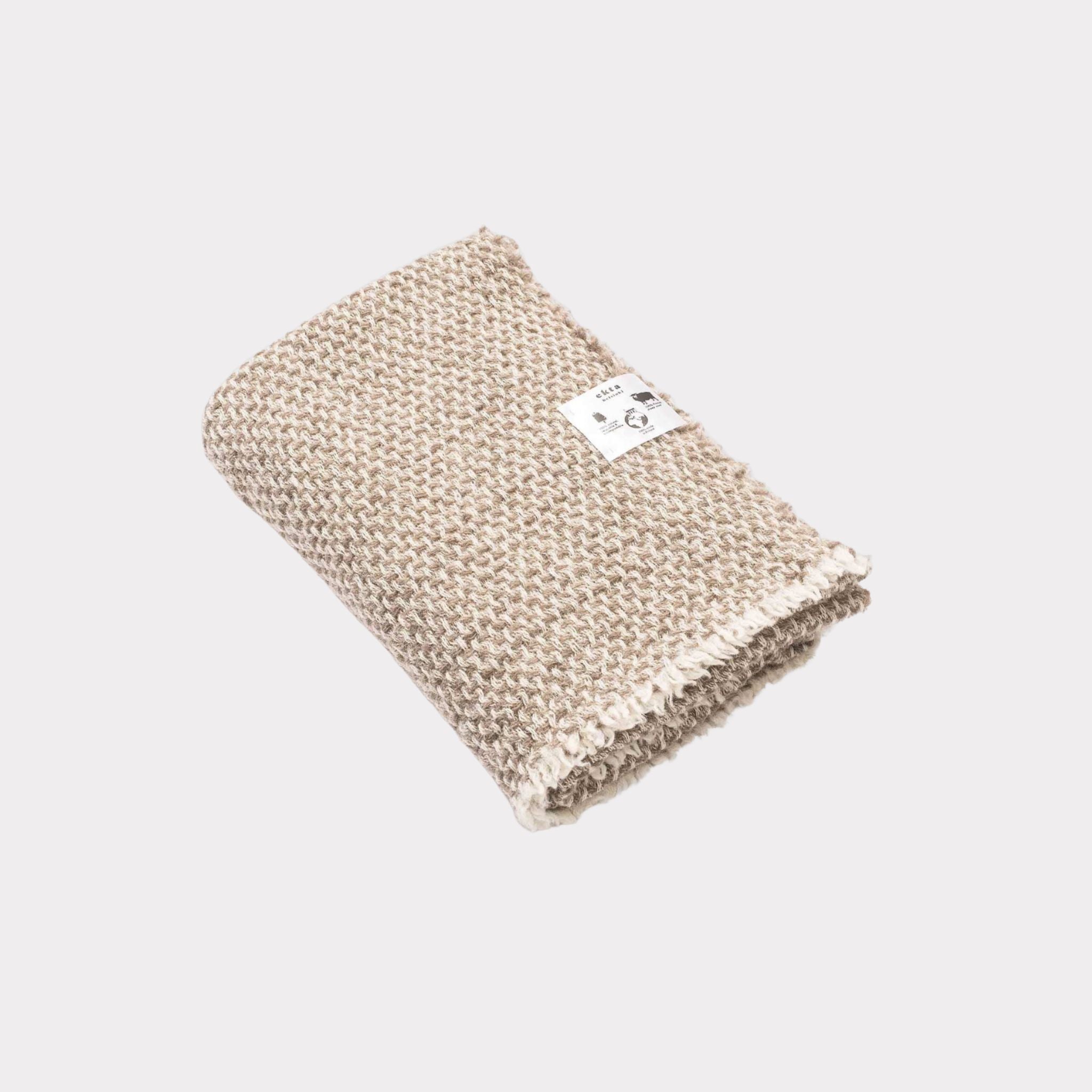 Textured white and beige throw made from responsibly sourced Finnish sheep wool, manufactured in Finland.