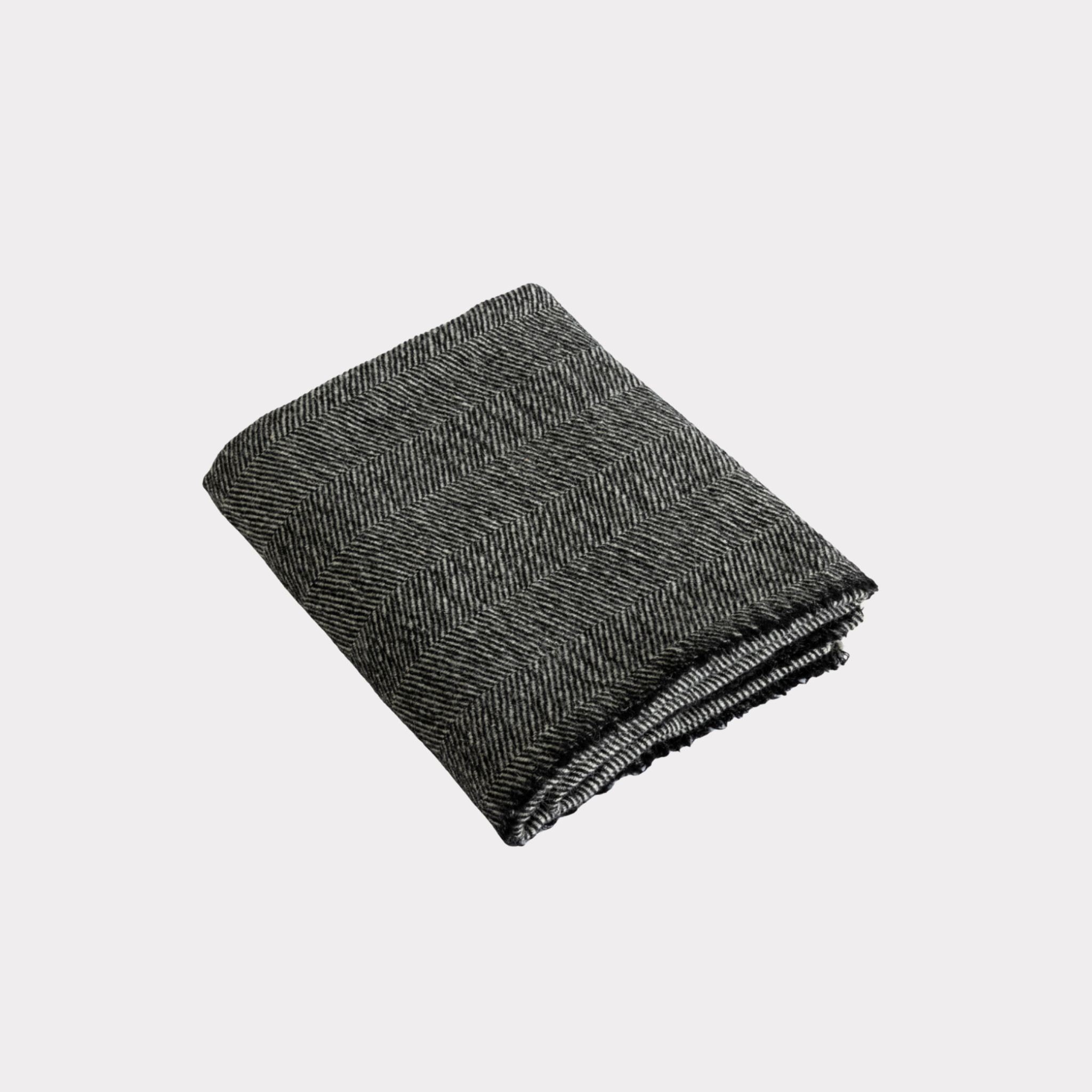 Black and light grey herringbone wool throw woven from 100% Finnish sheep wool