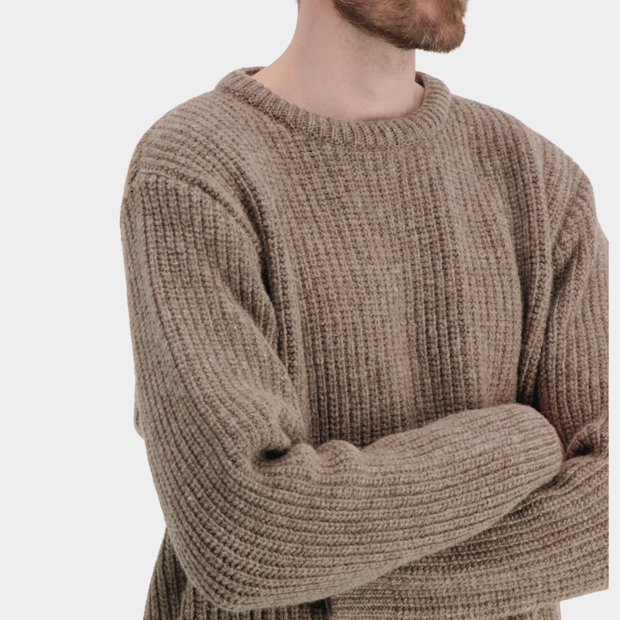 Soft beige knit sweater with round neckline, made from ethically sourced Finnish wool.
