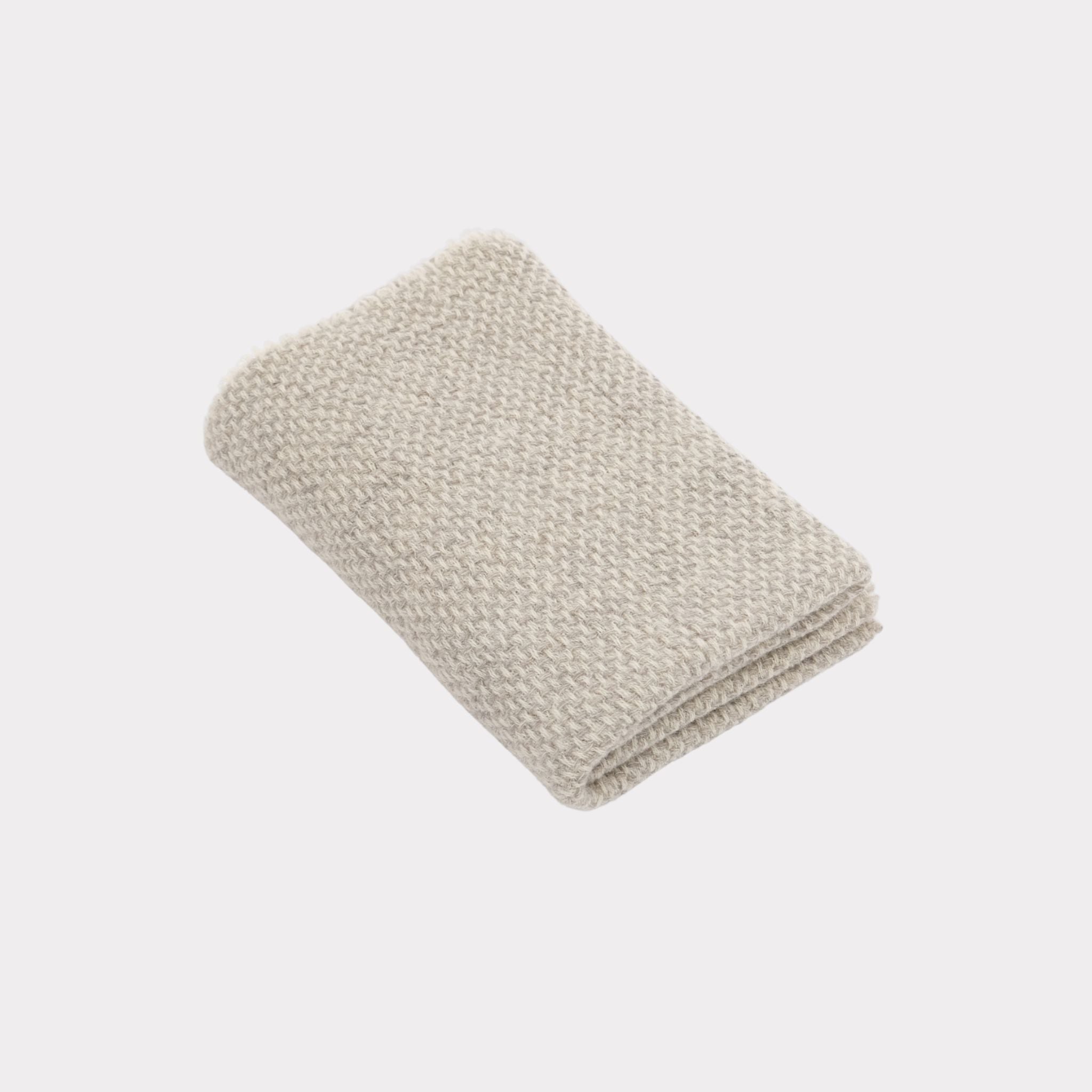 Textured white and light grey throw made from responsibly sourced Finnish sheep wool, manufactured in Finland.