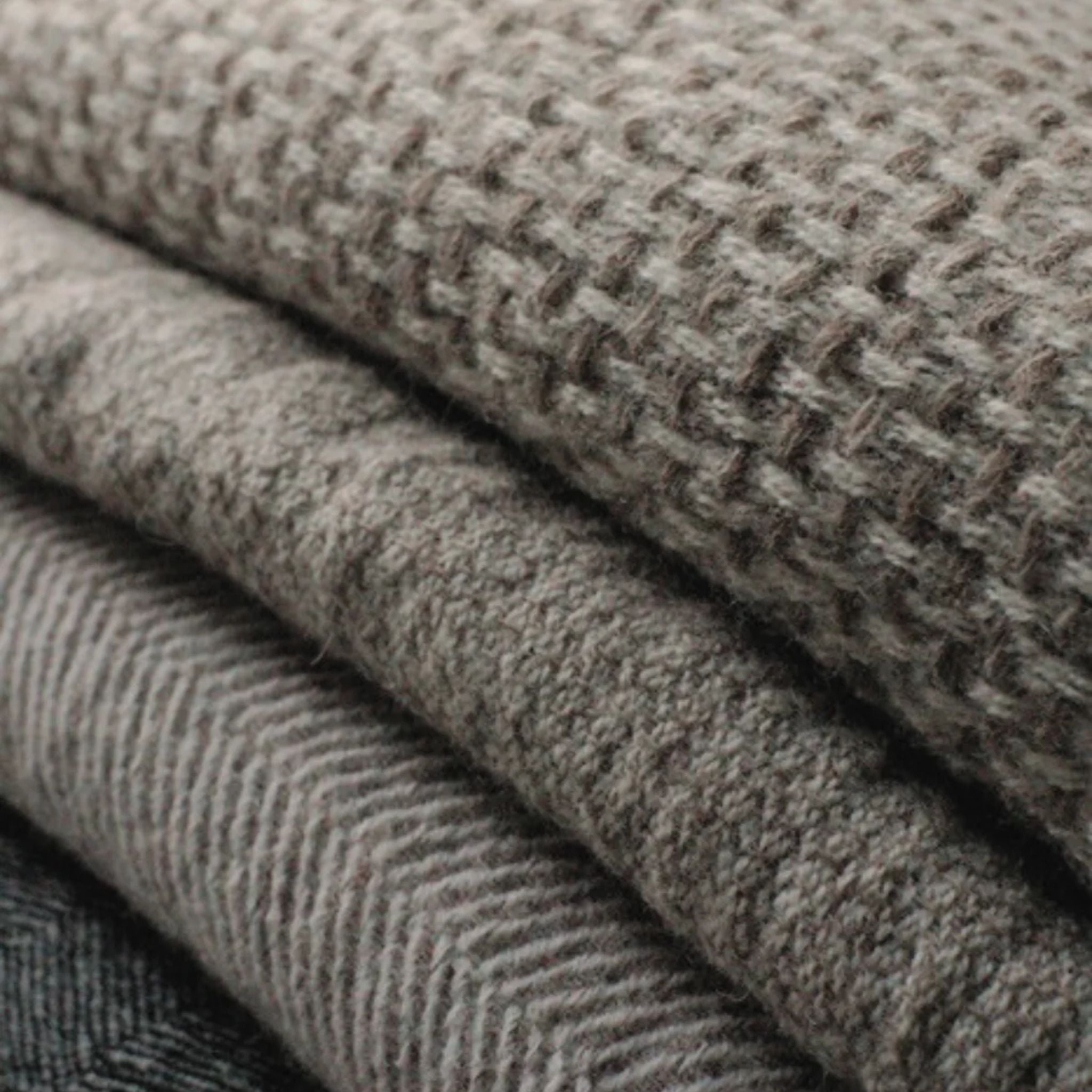 Textured white and light grey throw made from responsibly sourced Finnish sheep wool, manufactured in Finland.