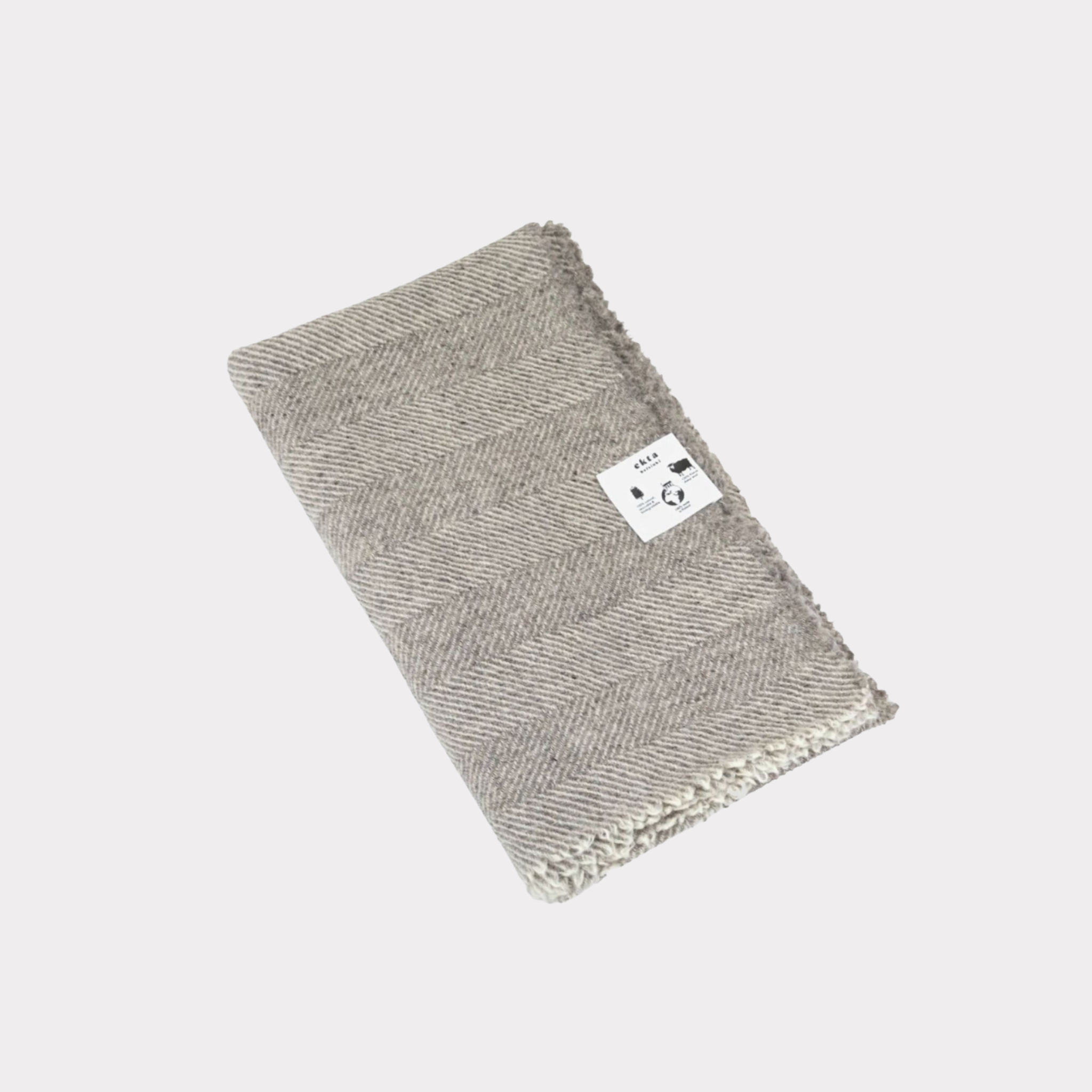 Herringbone pattern white and lgrey throw made from responsibly sourced Finnish sheep wool, manufactured in Finland.