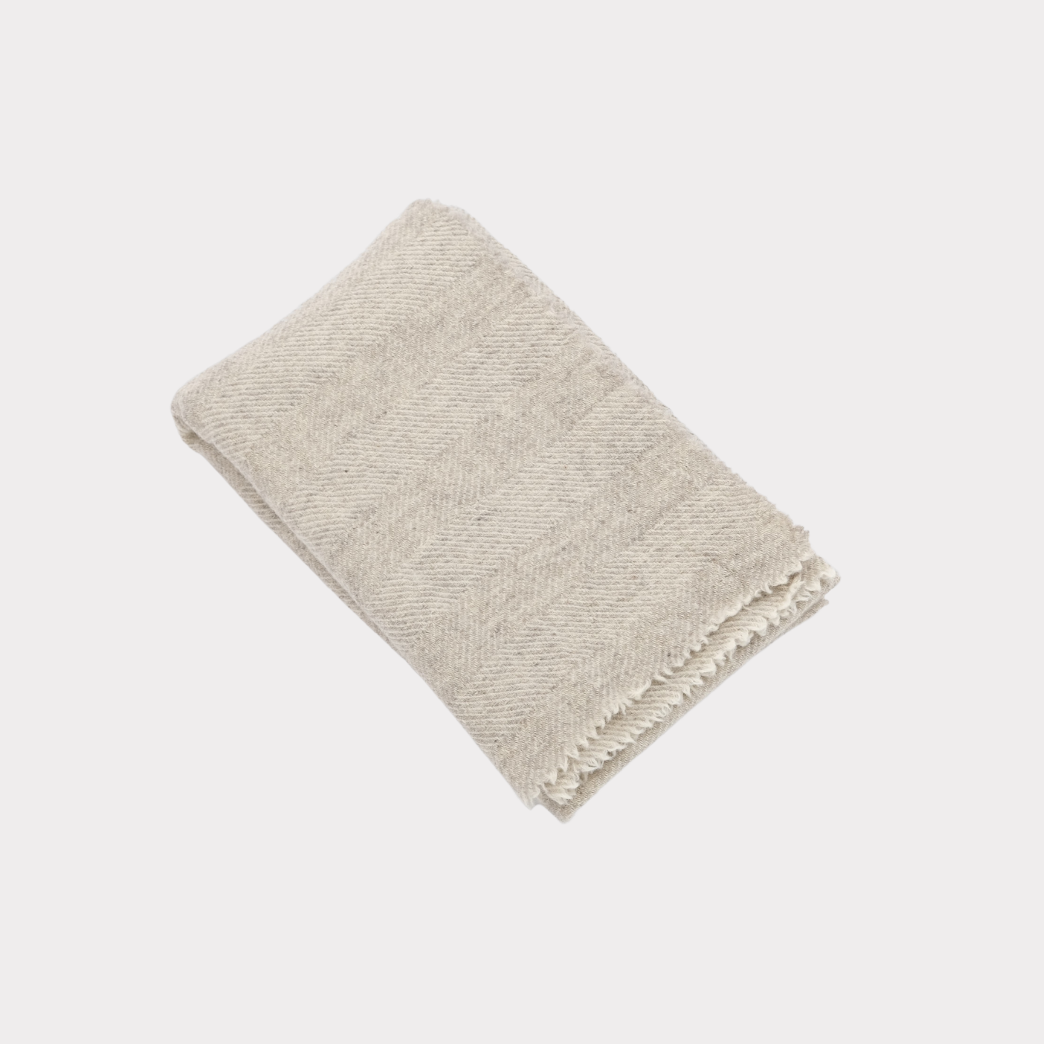 Herringbone pattern white and light grey throw made from responsibly sourced Finnish sheep wool, manufactured in Finland.